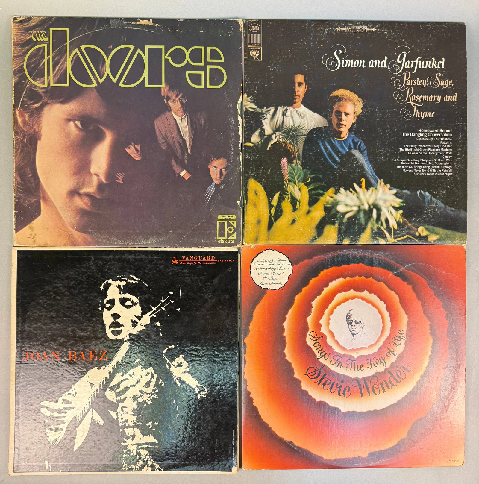 A Collection of Vintage 1960s-1970s Vinyl LP Records, including Stevie Wonder's 'Songs in the Key of: A collection of four vintage 12-inch vinyl LP records, predominantly featuring popular music from the 1960s and 1970s. The lot includes the double-LP gatefold album 'Songs in the Key of Life' by Stevi