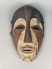 An African Carved and Pigmented Wooden Face Mask