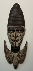 An African Carved and Polychrome Wood Tribal Mask with Cowrie Shell Inlays