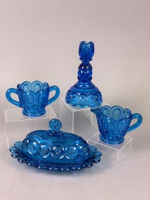 A Four-Piece Set of L.E. Smith Cobalt Blue Moon and Stars Pressed Glass Tableware