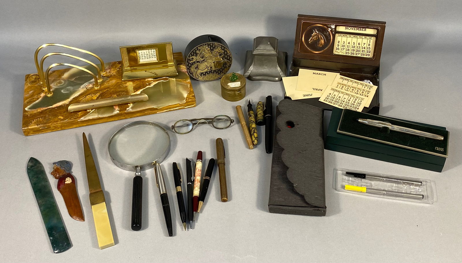 A Collection of Vintage and Antique Desk Accessories and Writing Instruments: A diverse collection of vintage and antique desk accessories and writing instruments, predominantly from the mid-20th century to contemporary periods. The collection includes a large rectangular onyx