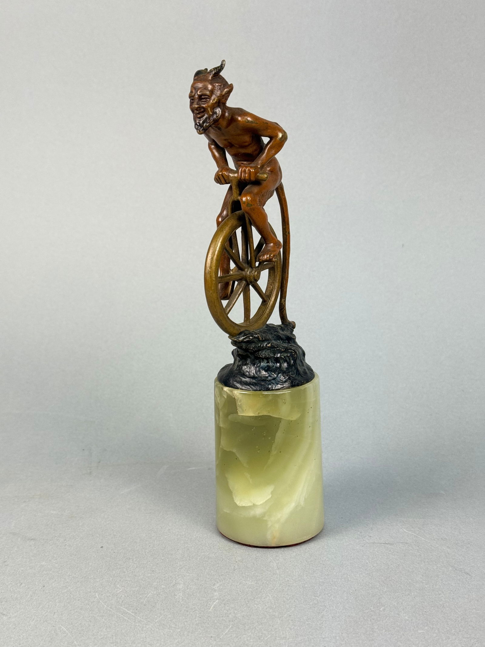 A Patinated Bronze Figural Sculpture of a Satyr on a Unicycle, Mounted on Onyx (1 of 7)