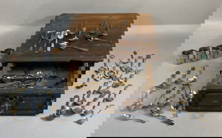 A Collection of Souvenir and Sterling Silver Spoons, Four Metal Cups, and a Wooden Storage Box