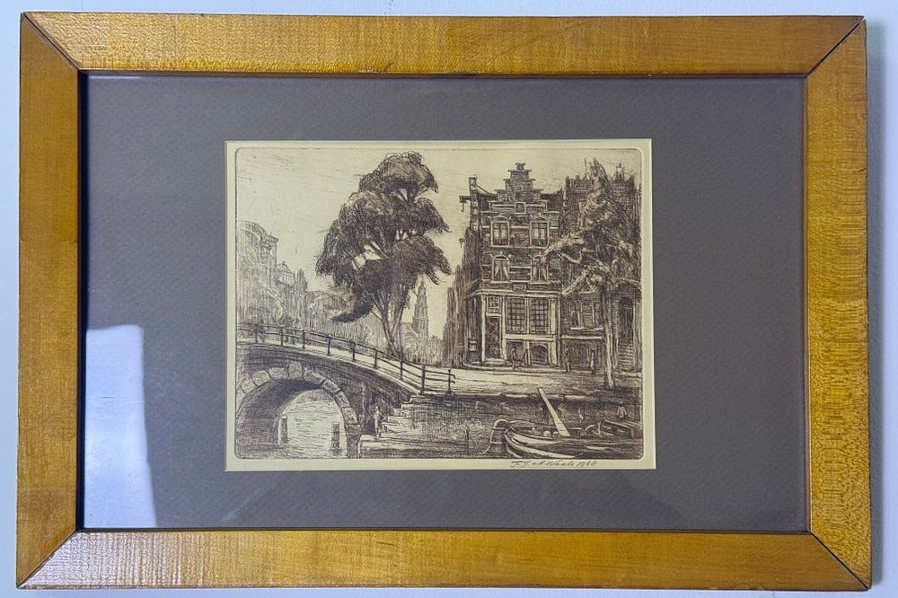 Mid-20th Century Etching of an Amsterdam Canal Scene, Signed F. J. v. d. Waele 1960: A mid-20th century monochromatic print, likely an etching or engraving, depicting a European city canal scene, consistent with Amsterdam. The composition features an arched bridge, gabled canal houses