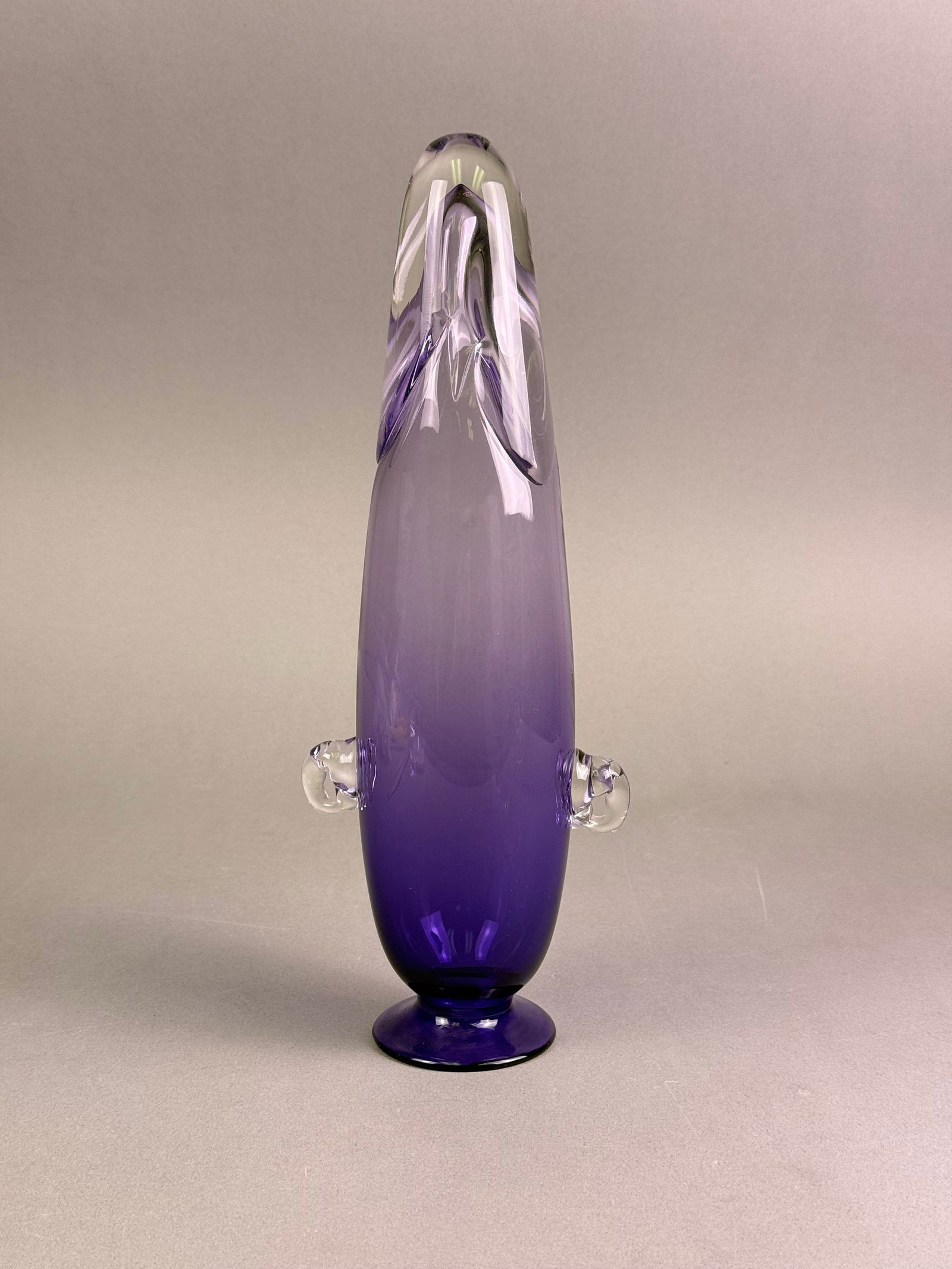 Per Lutken for Holmegaard, Treflojet Amethyst Glass Vase: A Treflojet vase designed by Per Lutken for Holmegaard. This elongated art glass vase of a modernist aesthetic is crafted from blown glass, exhibiting a deep purple hue that gradually lightens to a tr
