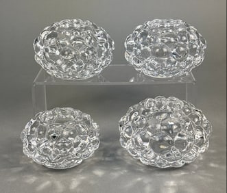 A Set of Four Orrefors Raspberry Votive Candle Holders