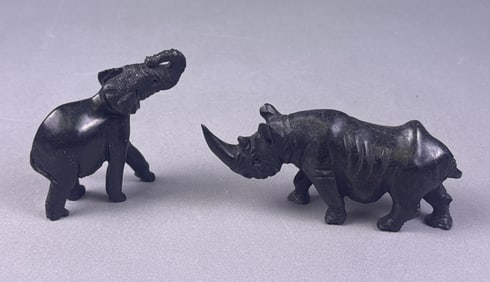 A Pair of African Carved Stone Elephant and Rhinoceros Figurines