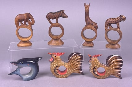 A Collection of Seven Carved Wooden Animal Napkin Rings, including Safari Animals, Roosters, and a