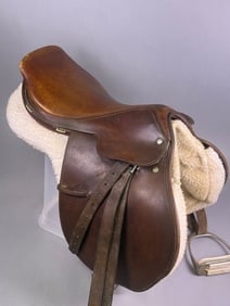 A Crosby and Olympic English Jump Saddle, with Stirrups and Girth