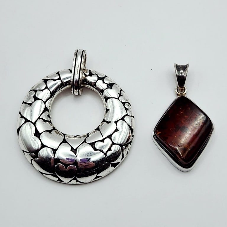 Sterling Pendants 37.5 Grams: The round pendant heart side acid tested sterling. Couldn't test the back.The amber pendant acid tested sterling.