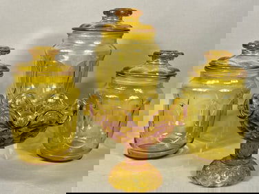 A Group of L.E. Smith 'Moon and Stars' Amber Pressed Glass Compote and Three Storage Jars