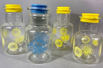 A Group of Four Vintage Pyrex Glass Juice Pitchers, including Cornflower Blue and Citrus Patterns