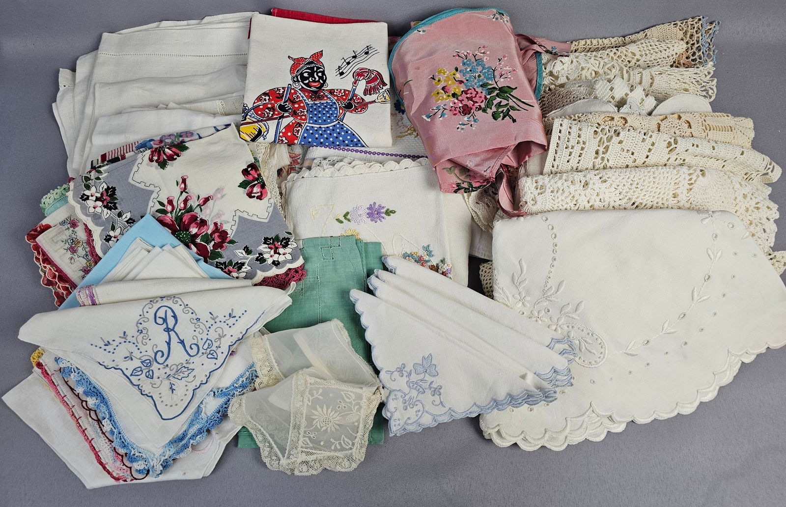 A Collection of Mid-20th Century Vintage Textiles, Including Handkerchiefs, Doilies, and Linens: This diverse collection of vintage textiles, predominantly from the mid-20th century, comprises a significant quantity of handkerchiefs, many featuring embroidered floral patterns, monogrammed initial