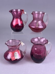 A Collection of Pilgrim Cranberry Glass Pitchers,