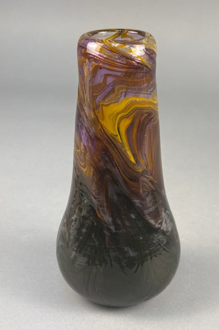 A Bohemian Style Art Glass Vase: A Bohemian style art glass vase, crafted from hand-blown glass. It features a free-form, organic shape with a slightly flared rim, a tapered neck, and a bulbous body tapering to a rounded base. The gl