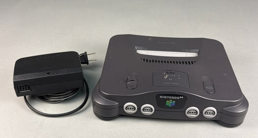A Nintendo 64 Video Game Console and Power Adapter
