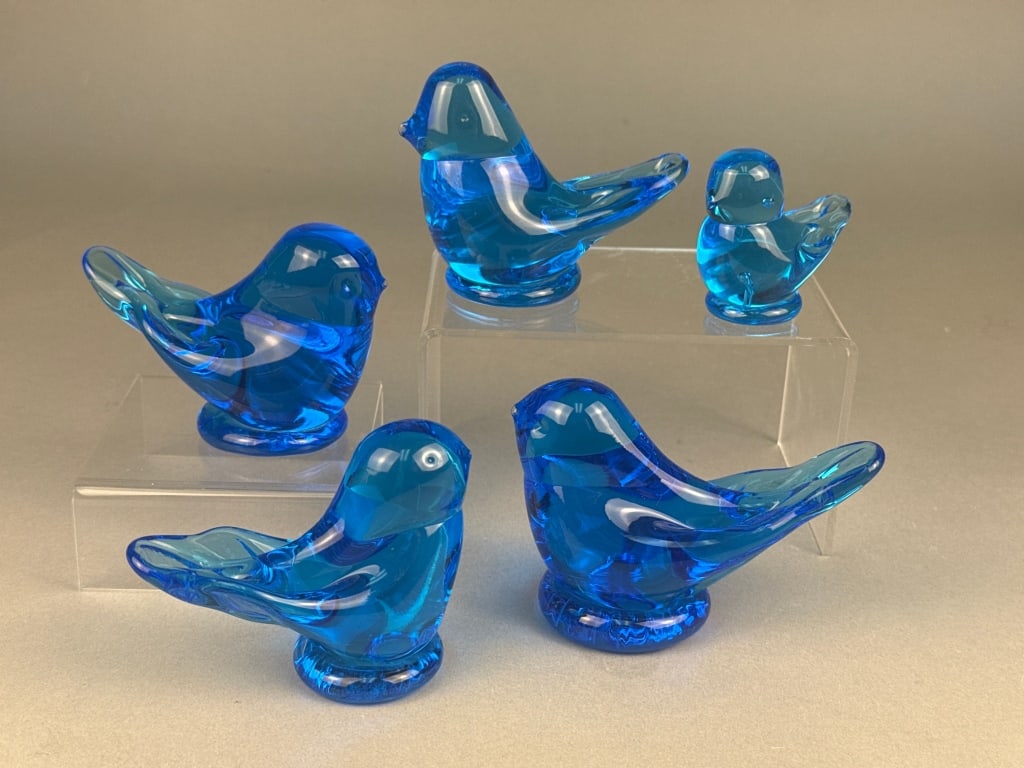 A Group of Terra Studios Blue Bird of Happiness Ar: A group of Terra Studios Blue Bird of Happiness art glass figurines, comprising five stylized bird figurines crafted from vibrant, deep cobalt blue glass, appearing to be solid or heavy blown glass, e