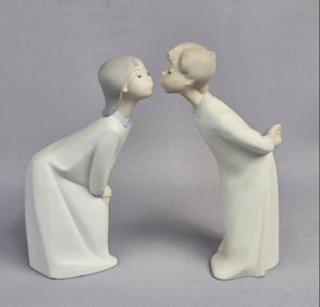 A Pair of Lladro 'Kissing Goodnight' Porcelain Fig