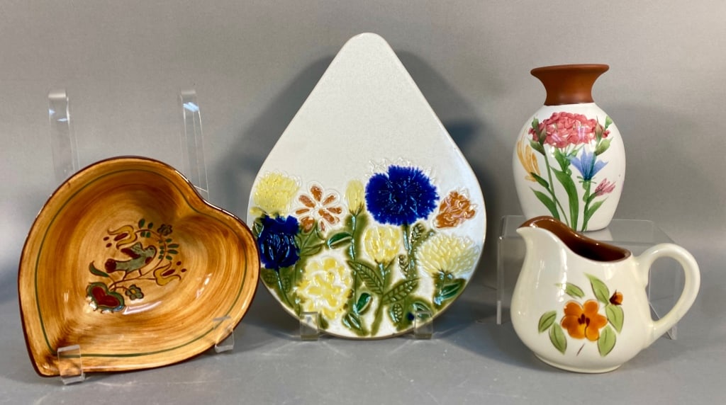 A Group of Four Glazed Ceramic Pottery Pieces by P: This lot comprises four pieces of glazed ceramic pottery. The first is a heart-shaped serving bowl by Pennsbury Pottery, marked "Pennsbury Pottery" in script on its crazed, unglazed base, featuring a