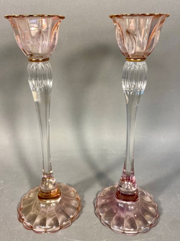 A Pair of Vintage Rose-Pink and Clear Glass Candle: A pair of vintage glass candlesticks, each featuring a clear, slender stem with a fluted section. The stem supports a rose-pink colored glass bobeche/cup with a scalloped, ribbed rim, accented with a