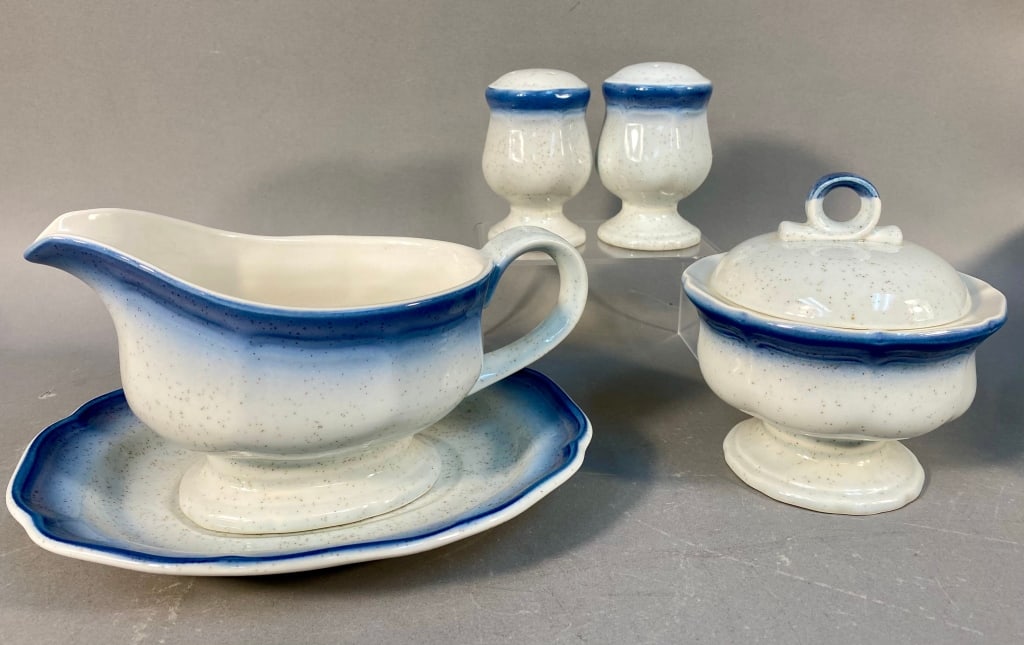 A Five-Piece Mikasa Country Club CA 500 Ceramic Di: A five-piece ceramic dinnerware set by Mikasa, in their 'Country Club CA 500' pattern. The set consists of a gravy boat with an attached underplate, a lidded sugar bowl, and a pair of salt and pepper