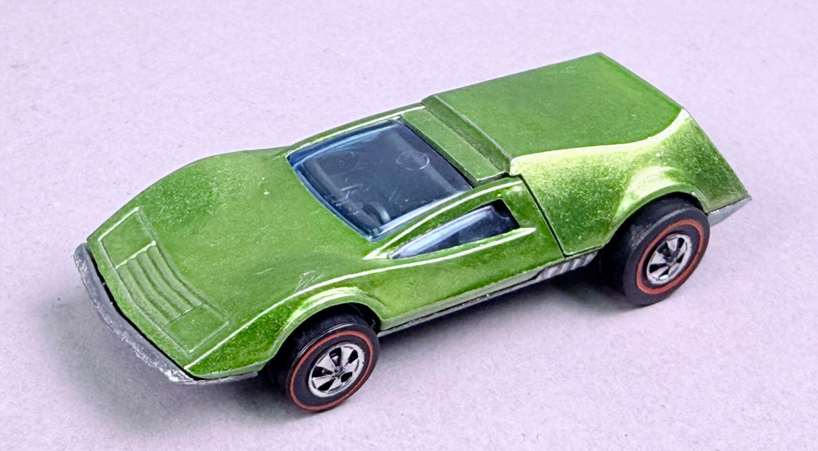 Hot Wheels Redline Tri-Baby Die-Cast Car Light Green Hong Kong: A vintage Hot Wheels Redline Tri-Baby die-cast toy car. The model features a wedge-shaped concept vehicle design with a Spectraflame finish in a light green hue, often identified by collectors as Ligh