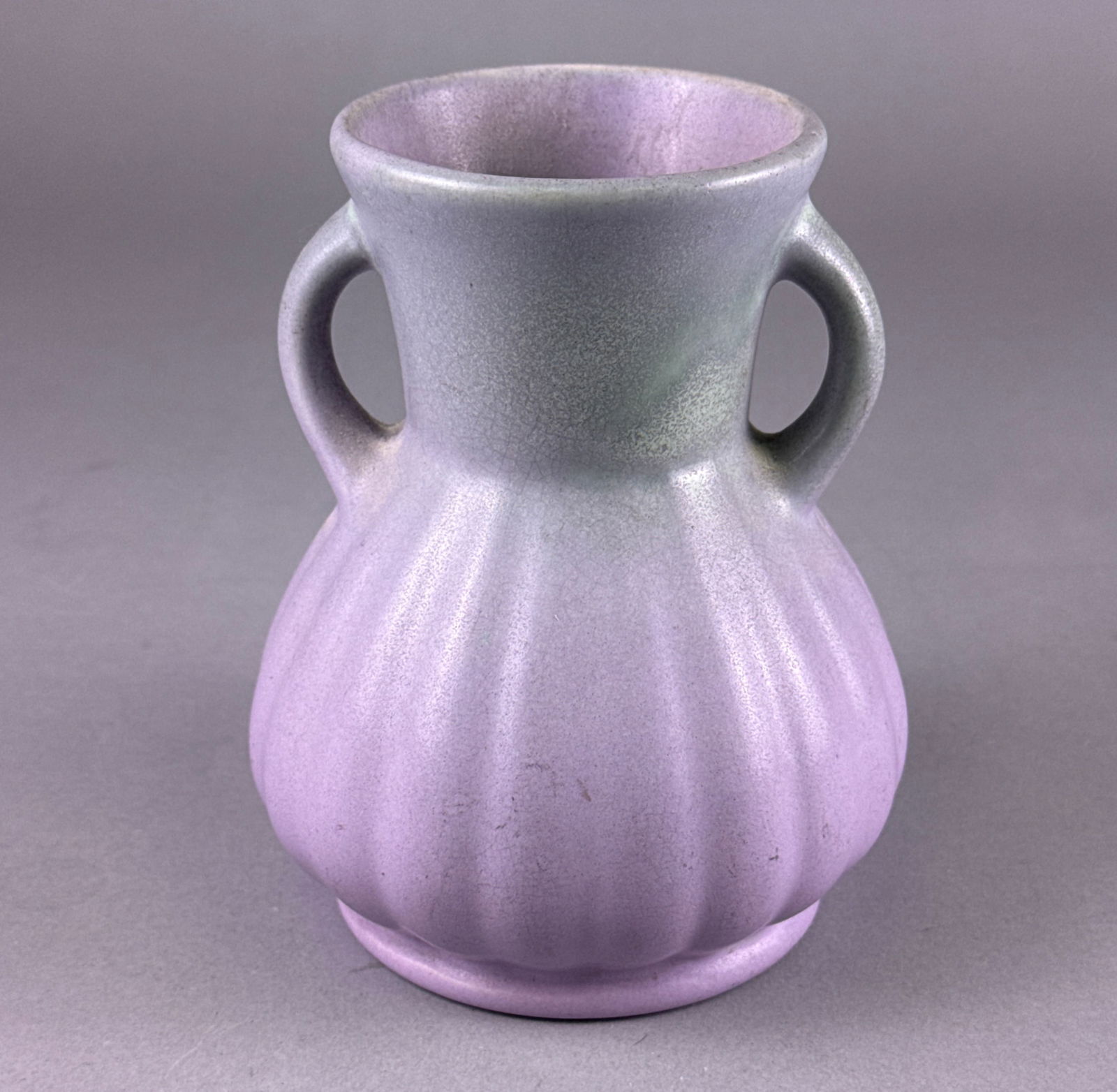 RumRill Pottery Two-Tone Handled Vase Model 320: A single ceramic vase attributed to RumRill Pottery, likely dating to the Mid-20th Century. The vase features a globular, fluted body rising to a short, smooth neck, flanked by two opposing loop handl
