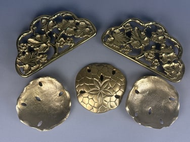 A Collection of Seven Harvin Virginia Metalcrafters Brass Trivets and Sand Dollar Dishes