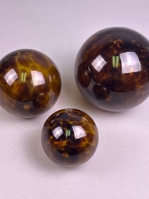 A Trio of Faux Tortoiseshell Resin Spherical Finials