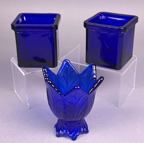 A Trio of Cobalt Blue Pressed Glass Candle Holders and Votive