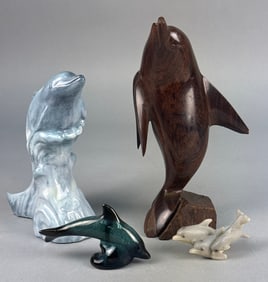 A Collection of Carved Ironwood and Ceramic Dolphin Figurines