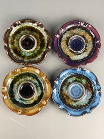 A Collection of Four Studio Art Pottery Candle Holders with Fused Crackle Glass
