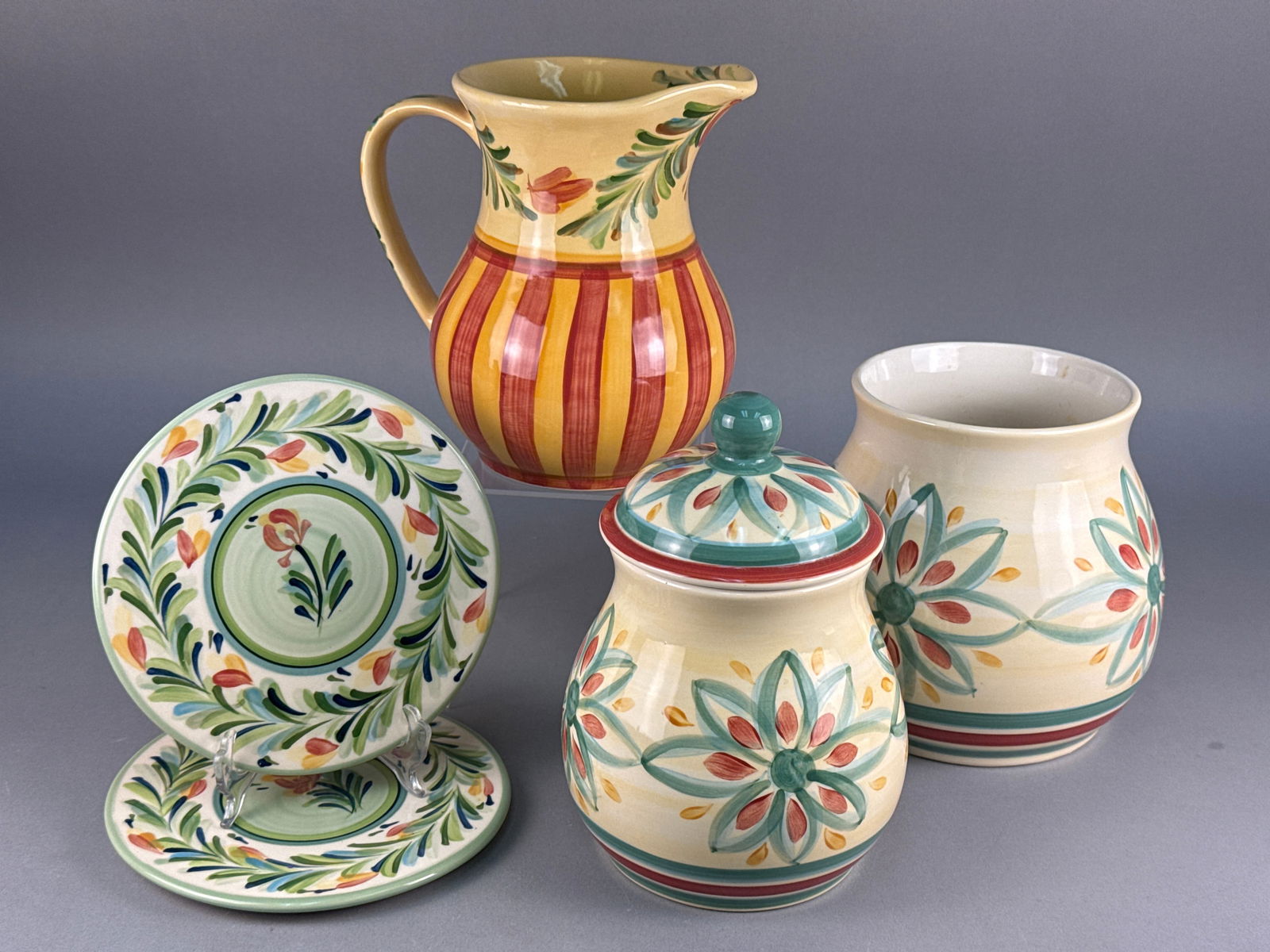 A Collection of Six Gail Pittman Hand-Painted Ceramic Tableware Items, Dated 1999: A collection of six pieces of hand-painted glazed ceramic tableware and kitchenware designed by Gail Pittman, dating to the Contemporary period, 1999. The lot comprises one large handled pitcher, one