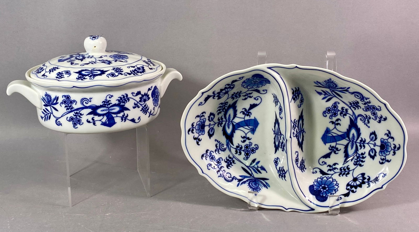 A Pair of Blue Danube Blue Onion Ceramic Serving Dishes (3 Pieces): A pair of ceramic serving dishes manufactured by Blue Danube in the classic Blue Onion (Zwiebelmuster) pattern. The lot consists of three total pieces: a covered oval serving dish (vessel and fitted l