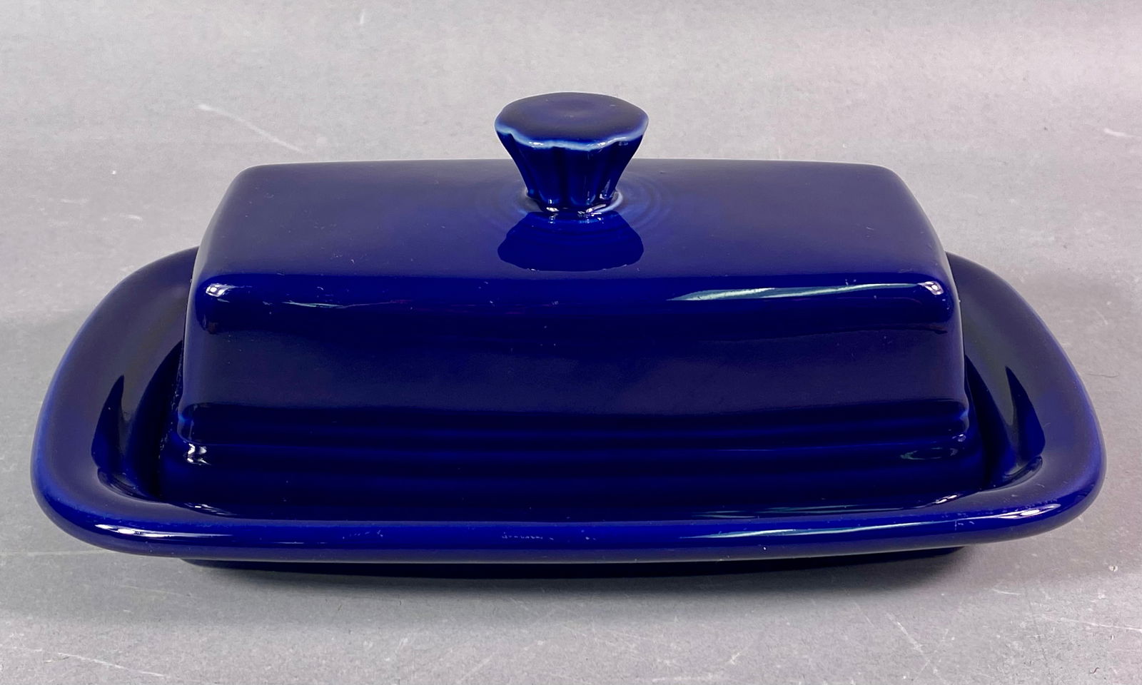 Fiesta Cobalt Blue Extra Large Covered Butter Dish, Two-Piece Set: A two-piece ceramic covered butter dish set manufactured by Homer Laughlin China (HLC) as part of the Fiestaware line. This is the Extra Large 1/4 Lb Covered Butter Dish form, finished entirely in a d