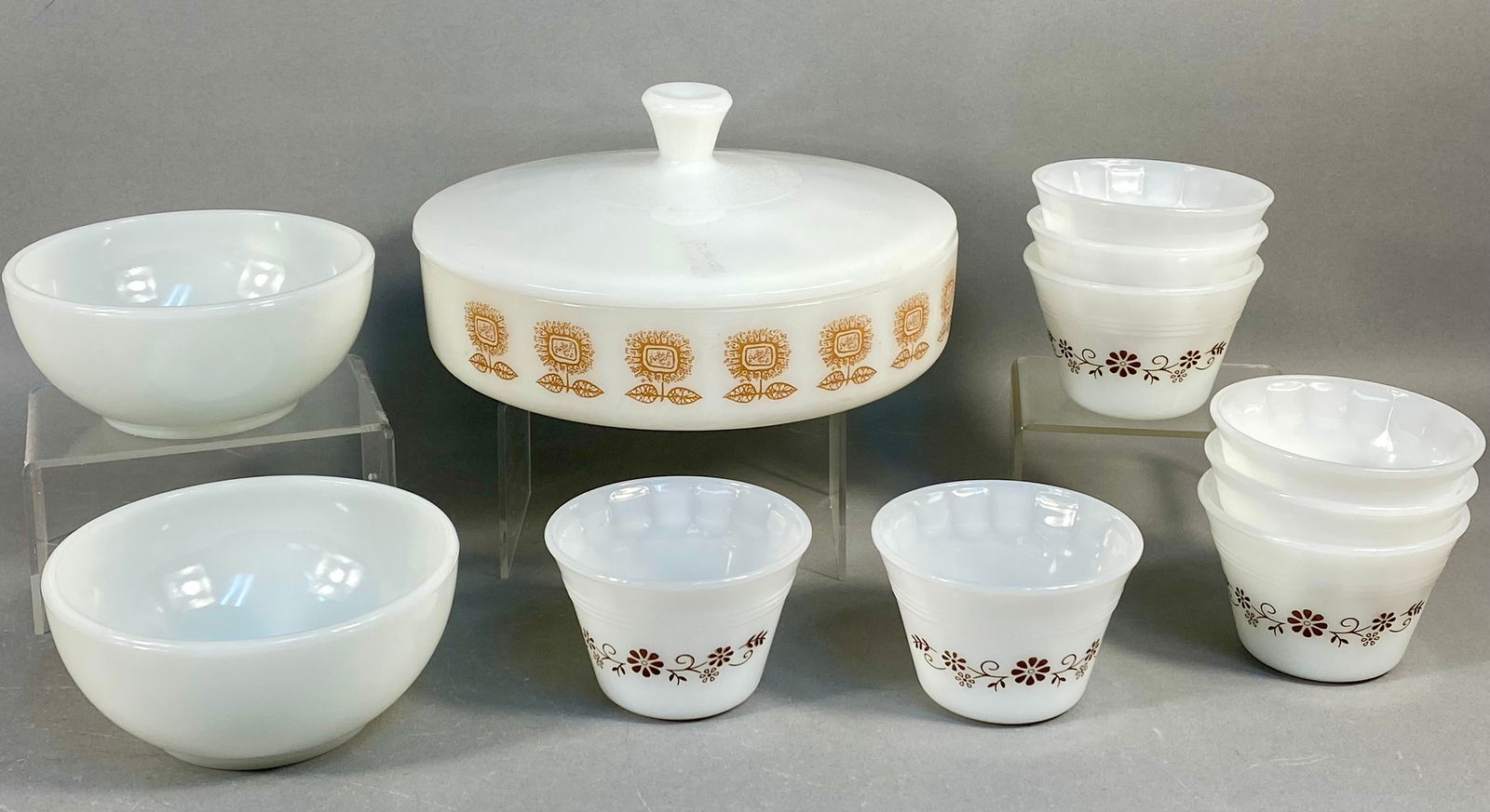 A Collection of Federal Glass Golden Sunflower and Mixed Milk Glass Kitchenware: A collection of 12 pieces of vintage opal milk glass kitchenware, primarily attributed to Federal Glass and Anchor Hocking, dating to the Mid-Century Modern period. The collection includes a Federal G