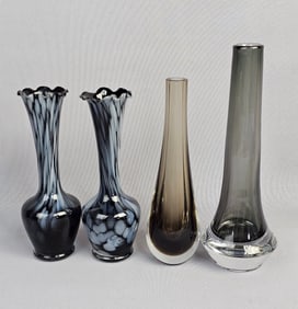 A Collection of Four Black Glass Vases
