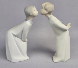 A Pair of Lladro Blowing Kisses Boy and Girl Figurines