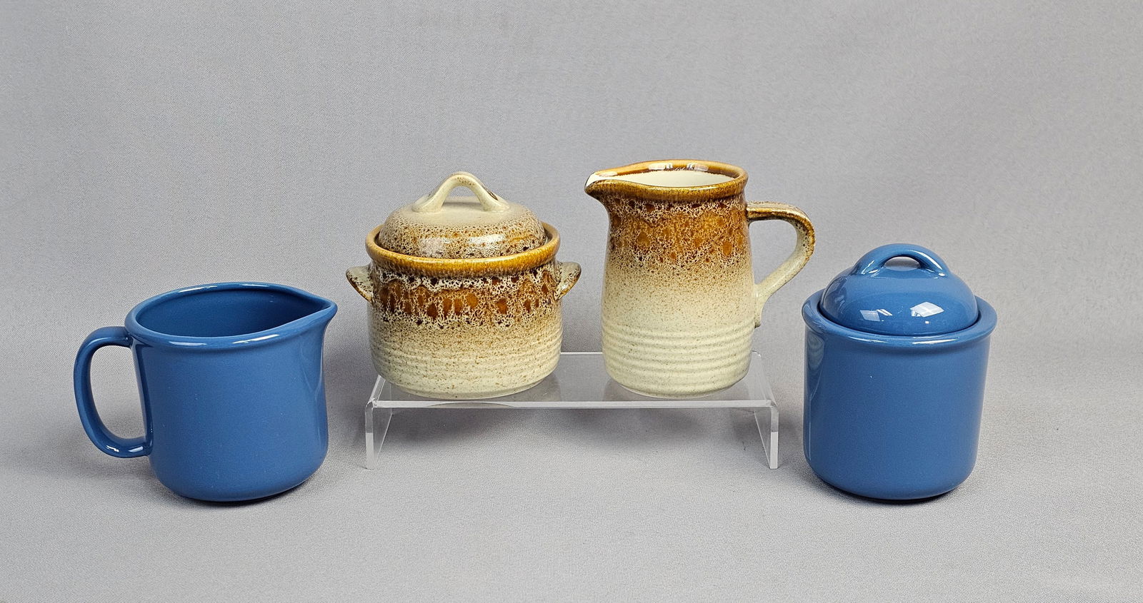 A Collection of Vintage Stoneware Serving Pieces including Mikasa Nature's Song Creamer and Sugar: A collection of stoneware ceramic pieces forming two mismatched vintage serving sets, both manufactured in Japan. The first set, identified by clear base markings and web consensus, is the Mikasa &quo