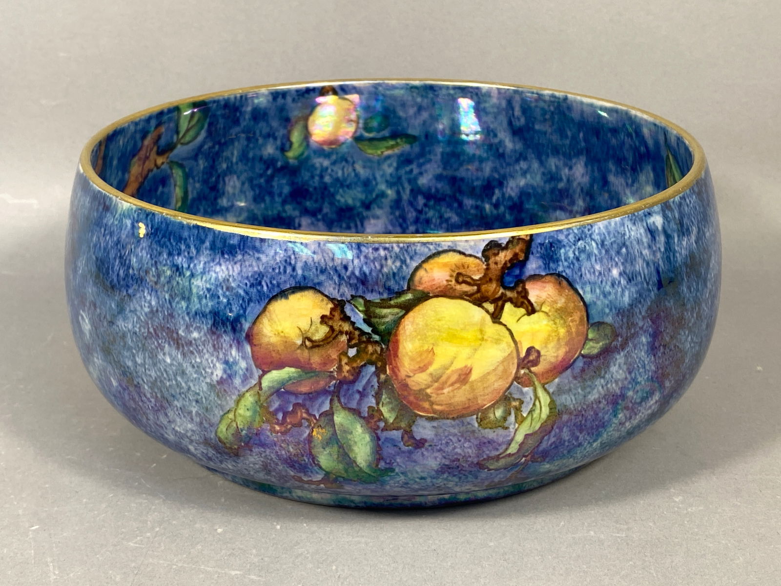 Grimwades Byzanta Ware Blue Luster Fruit Serving Bowl: A single ceramic serving bowl attributed to Grimwades, produced as part of their Byzanta Ware line, characteristic of early 20th-century English luster pottery. The rounded body features a deep cobalt