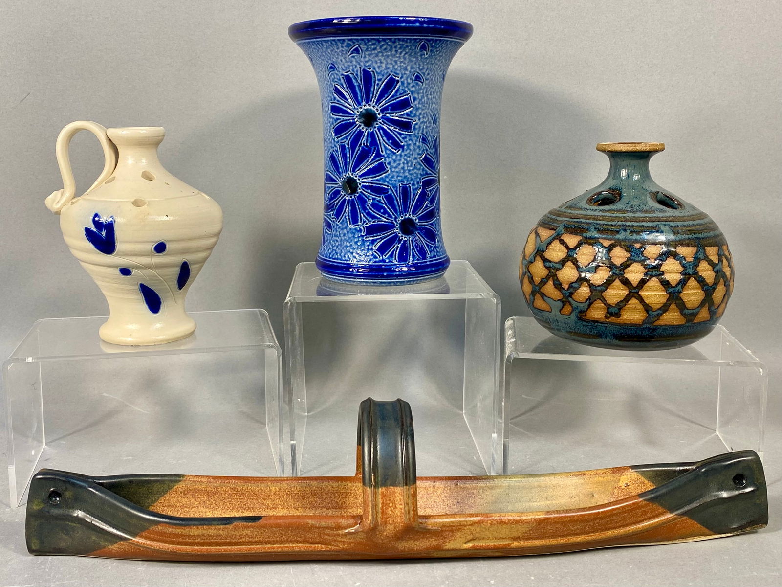 A Collection of Four Modern and Studio Stoneware Vessels and Tray: A collection of four pieces of modern or studio stoneware pottery, including three vases/vessels and one serving tray. The collection includes a tall stoneware vase with a flared rim, featuring a sti