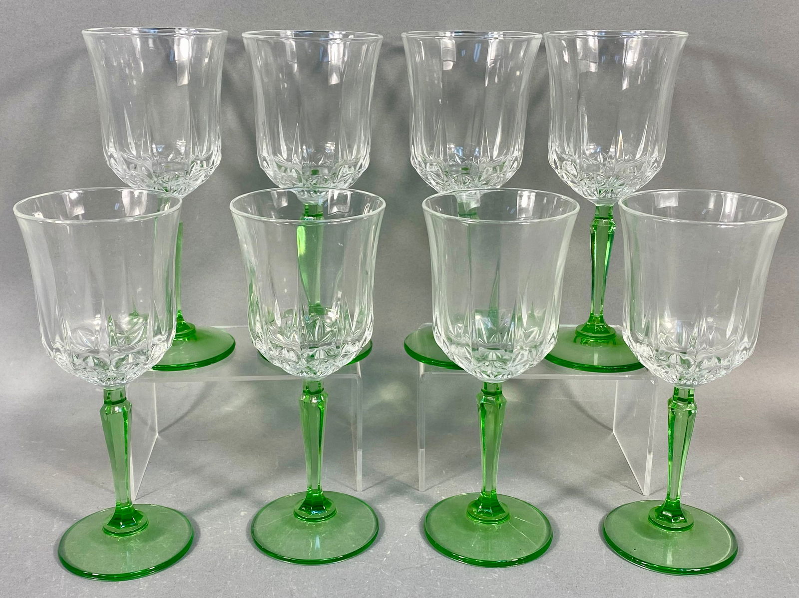 A Collection of 8 Saint George Glendale Green Stem Goblets: A collection of eight stemmed goblets, identified through market consensus as the Glendale pattern by Saint George. Each goblet features a flared bowl of clear pressed glass, decorated with a lower re