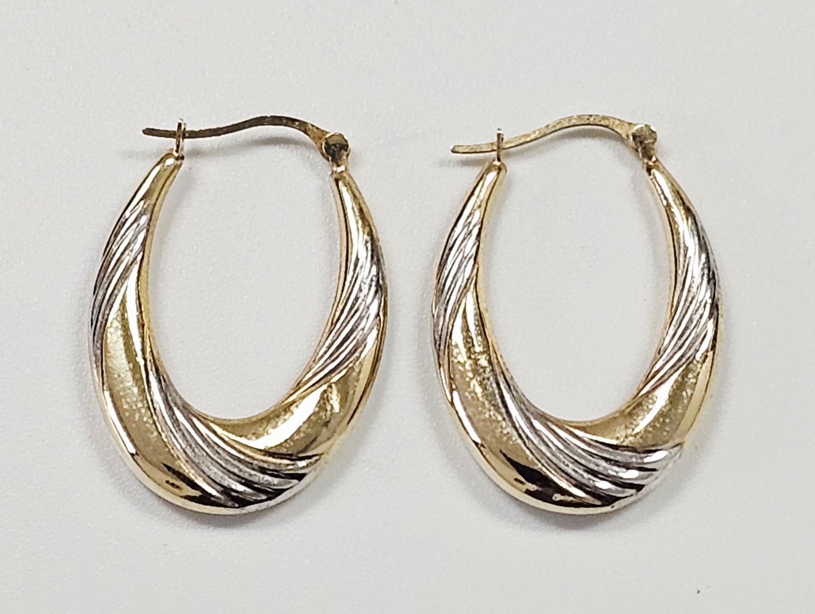 A Pair of 14k Two-Tone Gold Shrimp Style Hoop Earrings (1 of 7)