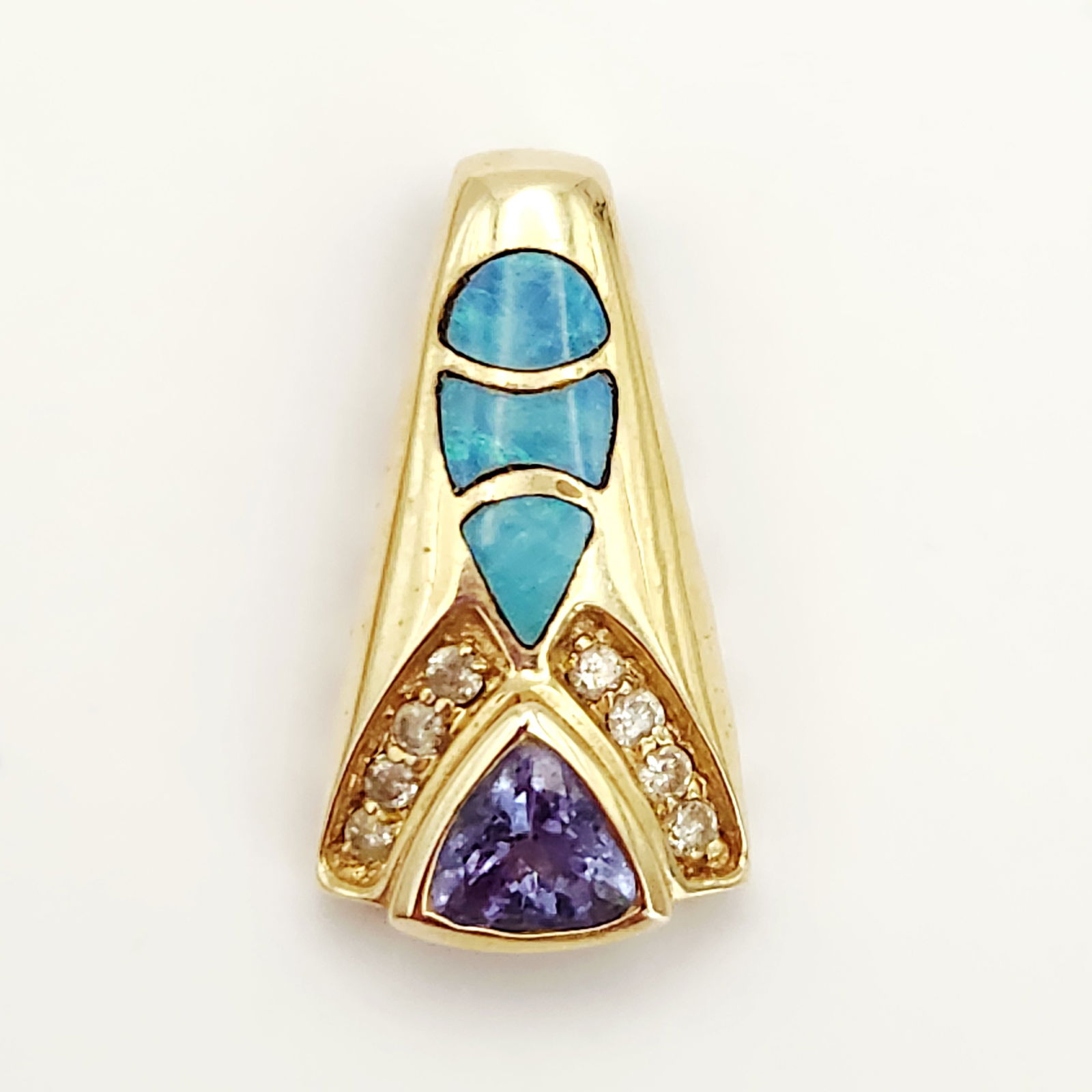 14K Gold Gemstone Pendant Slide 2.7 Grams: A contemporary 14K yellow gold tapered pendant slide featuring a geometric design. The piece is centered by a triangular-cut purple gemstone, likely tanzanite, flanked by two rows of small, accent dia