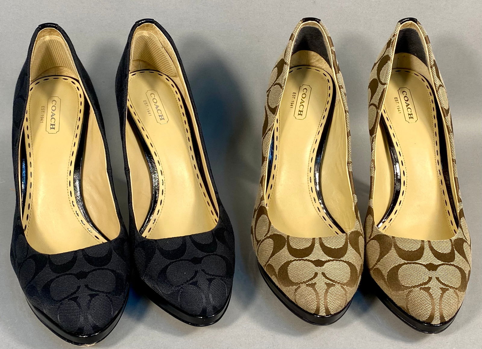 A Collection of Coach Caya Signature C Monogram Platform Pumps: A collection of Coach Caya platform pumps featuring signature C jacquard textile uppers in black and khaki colorways. Each shoe is constructed with black patent leather-covered stiletto heels and plat