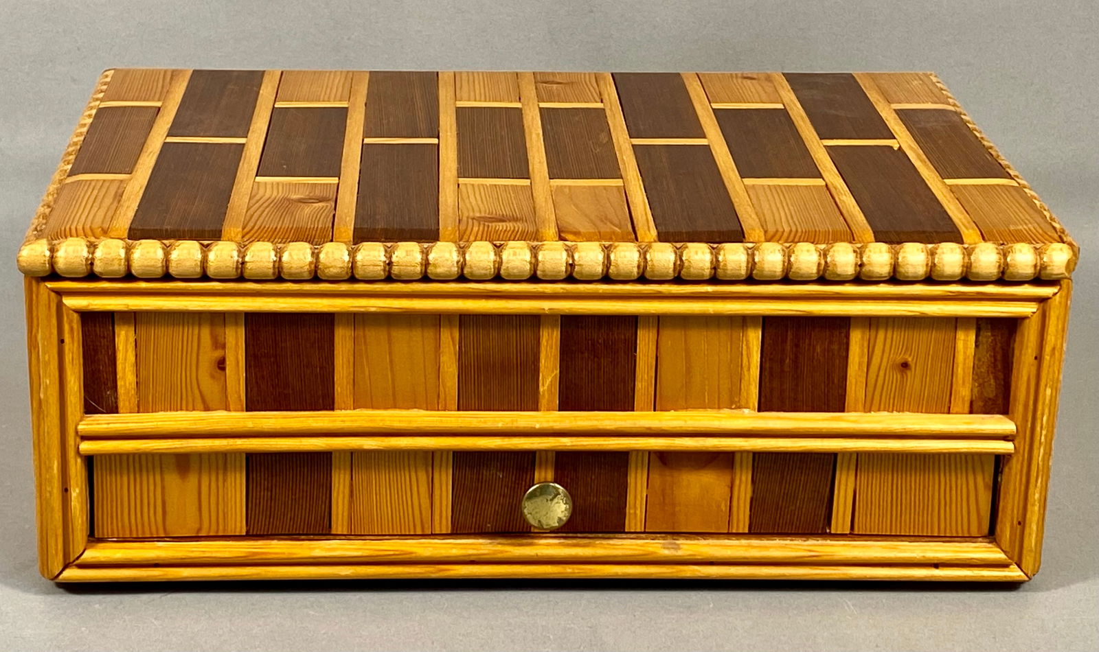 An Artisan Handcrafted Parquetry Wood Jewelry Box, Dated 1985: This handcrafted wooden jewelry box features an intricate parquetry pattern composed of contrasting light and dark wood tones across the exterior surfaces. The rectangular form is constructed with a h