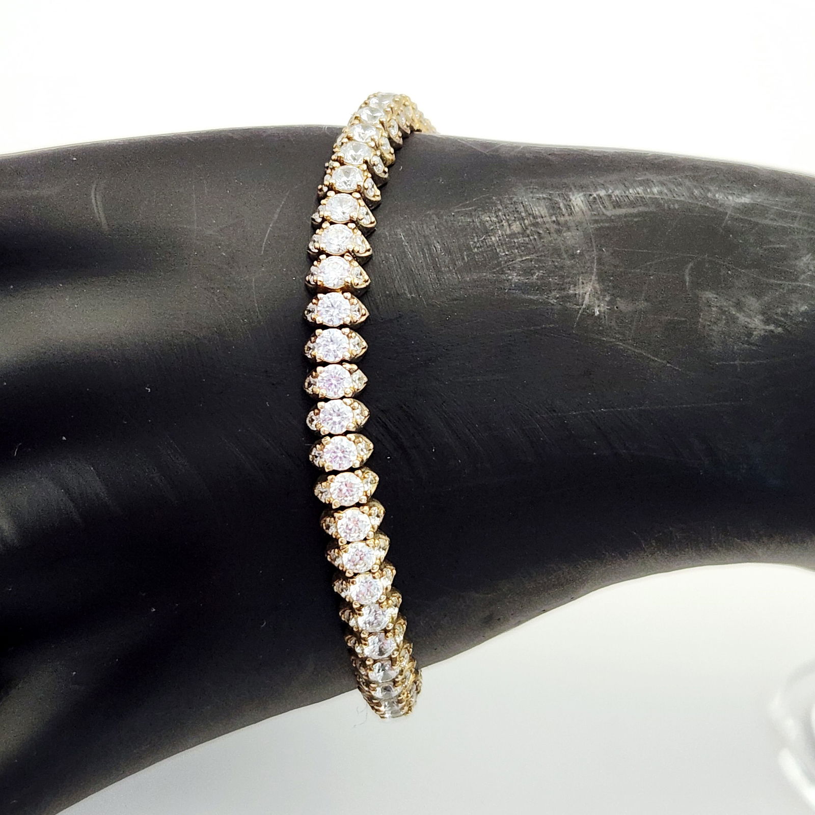 Vermeil CZ Tennis Bracelet 16.1 Grams: A gold-plated sterling silver tennis bracelet featuring a continuous row of round-cut clear stones in individual prong settings. The piece is constructed with a box clasp secured by dual figure-eight