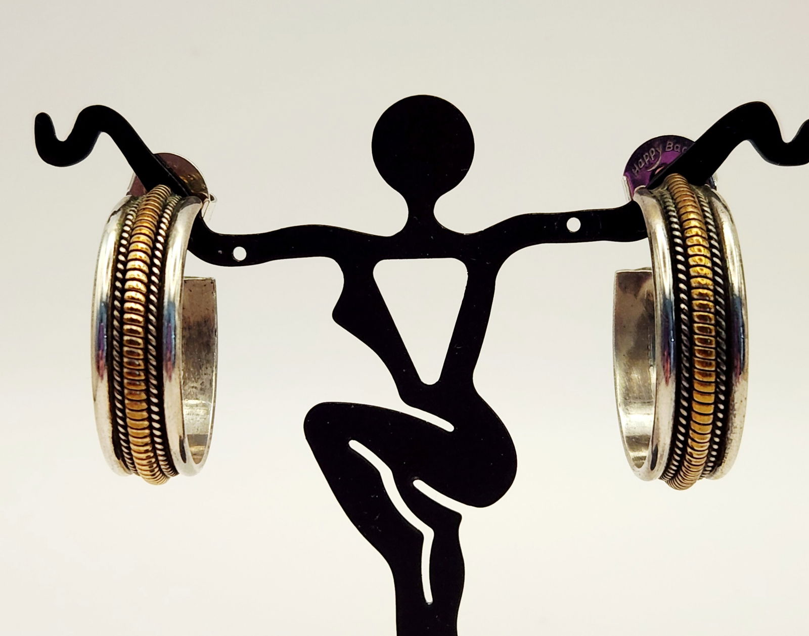 Tahe Navajo Sterling & 12K GF Earrings 20.5 Grams: A pair of Southwest-style hoop earrings by Navajo artist Tahe. Each earring is crafted from a wide, flat sterling silver band featuring a raised central channel with 1/20 12K gold-filled rope-twist