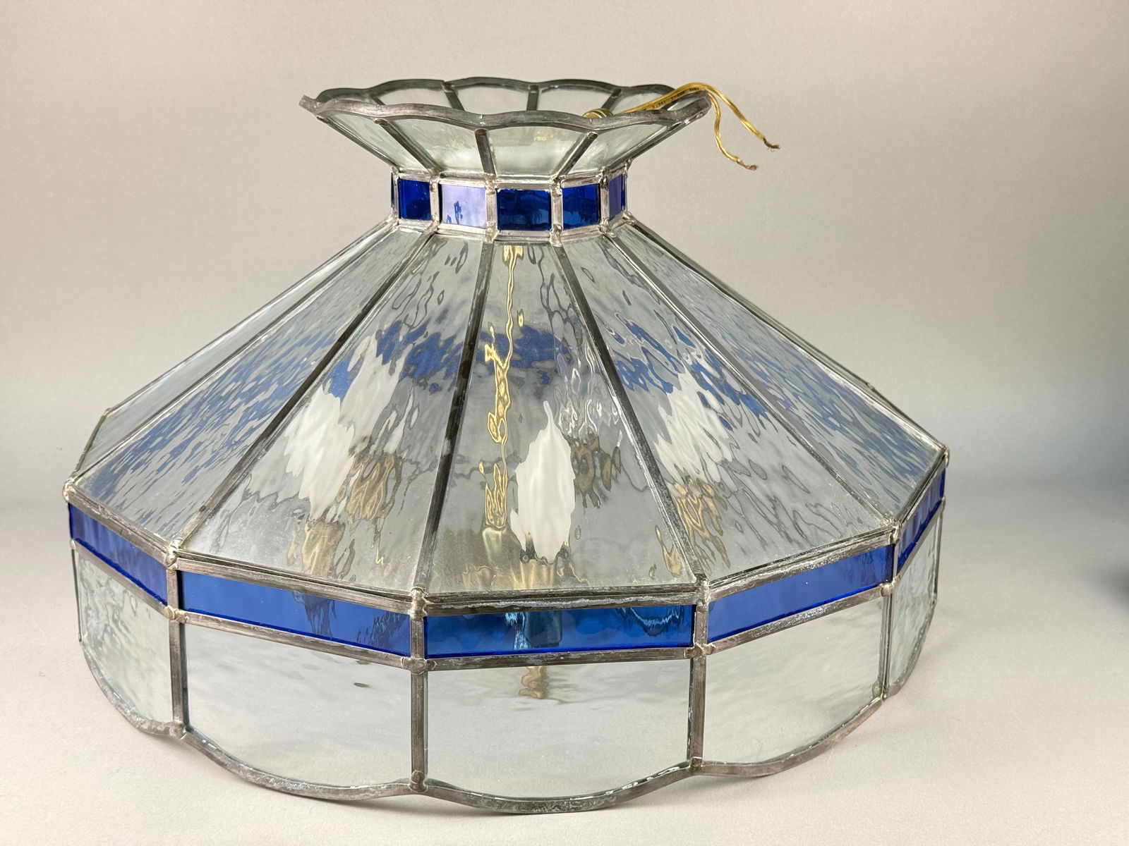 Glass Lighting de Guadalajara Leaded Glass and Cobalt Pendant Light Fixture: This pendant light fixture is manufactured by Glass Lighting de Guadalajara S.A. de C.V. in Mexico. The piece features a flared, octagonal shade constructed from hammered clear glass panels with cobal