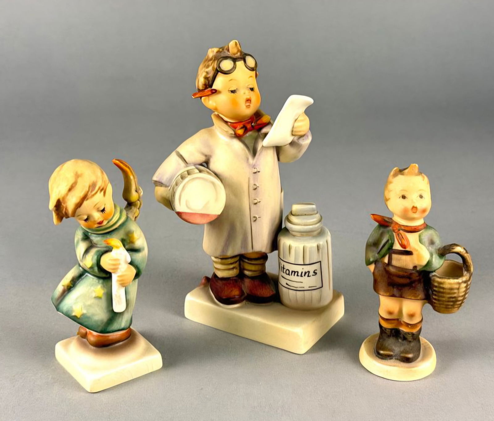 A Trio of Goebel M.I. Hummel Hand-Painted Ceramic Figurines (1 of 9)